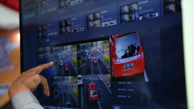 Petugas Ditlantas Polda Metro Jaya menjelaskan sistem tilang elektronik kepada warga saat Grand Launching Electronic Traffic Law Enforcement (E-TLE) di kawasan Bundaran HI, Jakarta